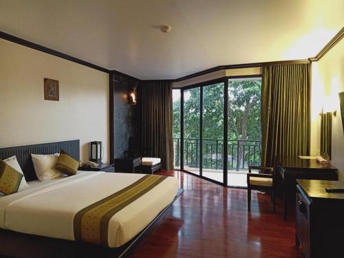 a hotel room with a bed and a balcony at khaoyai lumtakong hotel in Mu Si