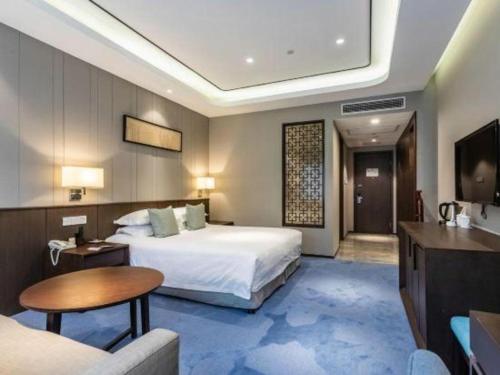 a hotel room with a bed and a couch at International Conference Hotel Nanjing in Nanjing