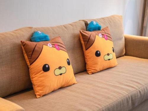 three pillows with hello kitty faces on a couch at International Conference Hotel Nanjing in Nanjing