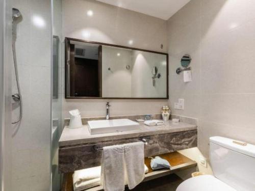a bathroom with a sink and a toilet at International Conference Hotel Nanjing in Nanjing