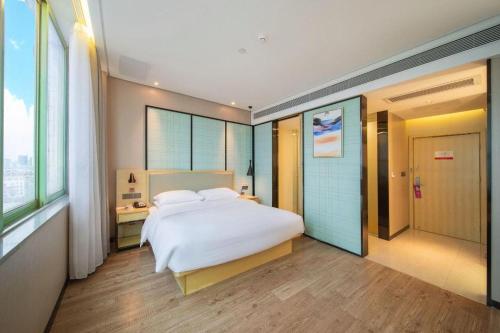 Postel nebo postele na pokoji v ubytování Echarm Hotel Yangjiang Baili Plaza
