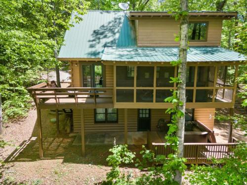 a house in the woods with a green roof at JW Hidden Lakes in Ellijay