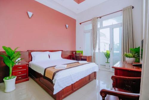 a red bedroom with a bed and a window at Hotel 175 Saigon in Ho Chi Minh City
