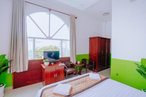 a bedroom with a bed and a desk with a computer at Hotel 175 Saigon in Ho Chi Minh City