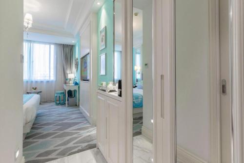 a hotel room with a bed and a bathroom at Kunming Noah's Ark Hotel in Kunming