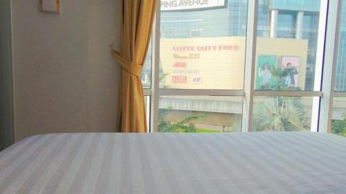 a bedroom with a bed and a window with a view at An Hotel Jakarta in Jakarta