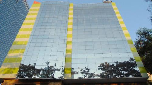 a tall building with yellow and yellow squares on it at An Hotel Jakarta in Jakarta