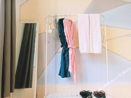 a group of towels and shoes hanging on a wall at Beihai forget dust International Youth Hostel in Beihai