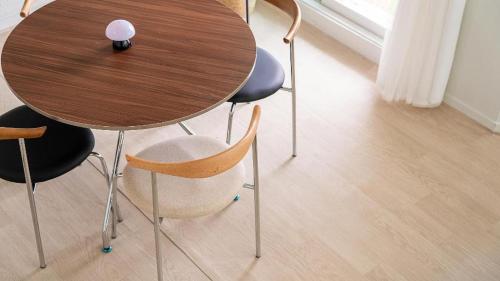 a wooden table and chairs with a purple ball on top at Gallery Pension in Taean