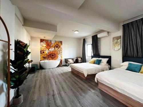a hotel room with two beds and a bathroom at Blue Saipan Garden in Saipan