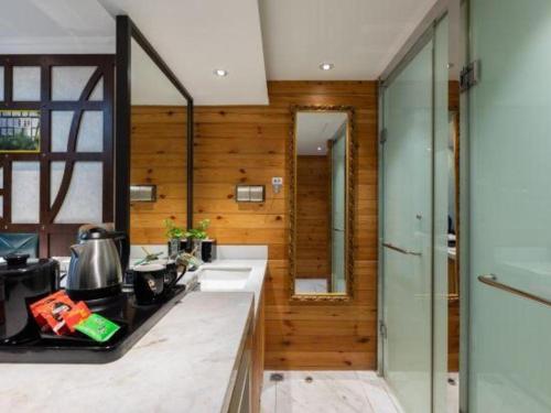 a kitchen with wooden walls and a counter top at Zaozhuang Hotel in Zaozhuang