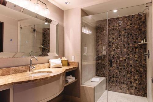 a bathroom with a sink and a shower at Blue Chip Casino Hotel Spa in Michigan City