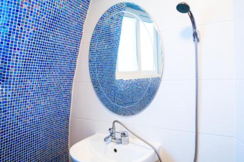 a bathroom with a sink and a mirror at All That Water Pension in Gapyeong