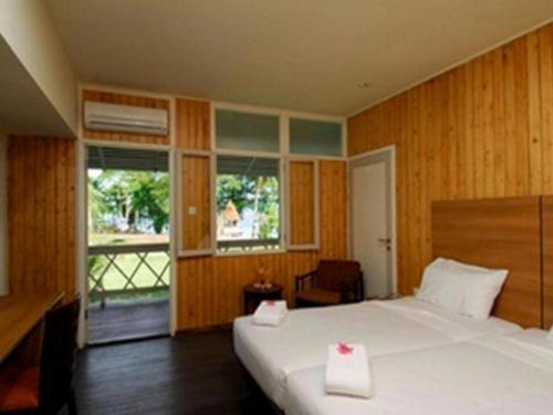 Ένα ή περισσότερα κρεβάτια σε δωμάτιο στο Asana Biak Papua Hotel