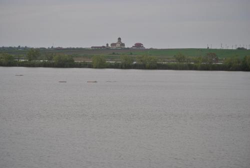 a large body of water with a building in the distance at Lacul Racilor in Olimp