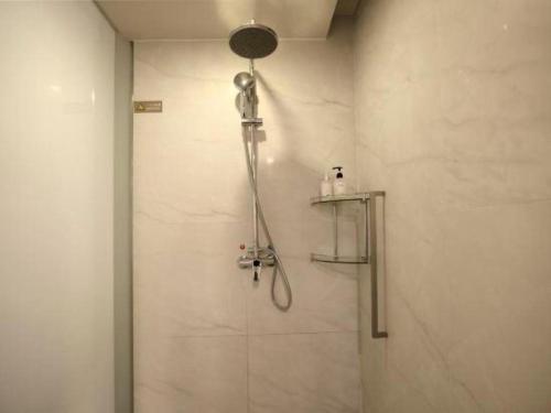 a shower with a shower head in a bathroom at Jinjiang Metropolo Hotel - Qingdao Chengyang District Government in Qingdao