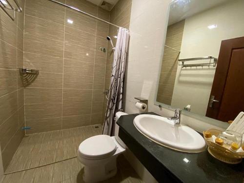 a bathroom with a sink and a toilet and a shower at ICON Hotel in Phnom Penh
