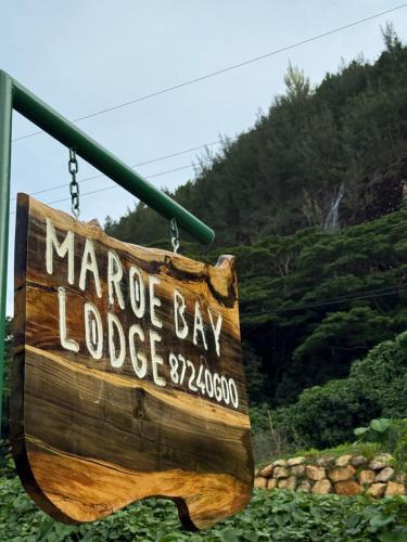 a sign that reads at Maroe Bay Lodge in HUH
