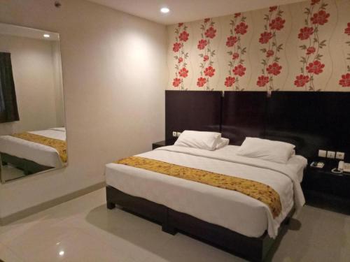 Кровать или кровати в номере Jelita Bandara Hotel Airport