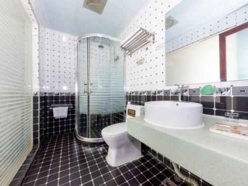 a bathroom with a sink and a toilet and a shower at Super 8 Hotel Shiyan Beijing Middle Road in Shiyan