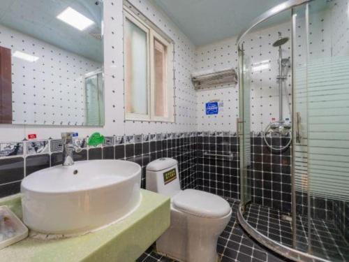 a bathroom with a sink and a shower and a toilet at Super 8 Hotel Shiyan Beijing Middle Road in Shiyan