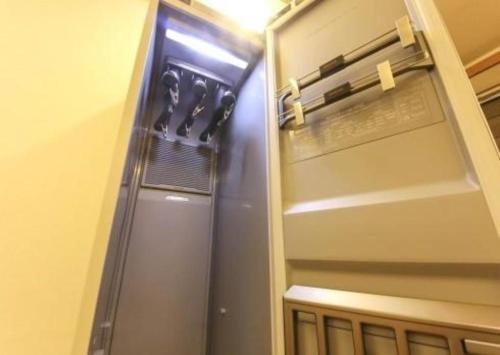 a refrigerator with its door open in a room at H Hotel in Ulsan