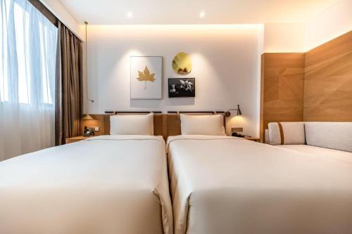 Postel nebo postele na pokoji v ubytování Atour Hotel Shenzhen Nanshan Vanke Yuncheng
