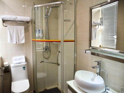 a bathroom with a shower and a toilet and a sink at Super 8 Hotel Yiwu Binwang in Yiwu