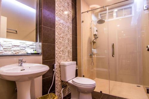 a bathroom with a toilet and a sink and a shower at At Home at Udon in Udon Thani