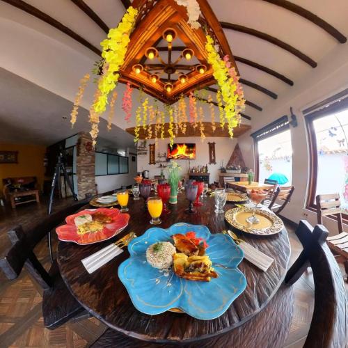 a dining room table with food on top of it at Casa De Las Flores Hotel SPA in Villa de Leyva