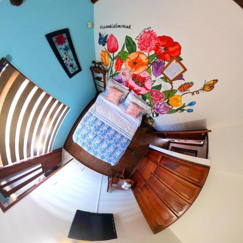 a room with a vase of flowers on the wall at Casa De Las Flores Hotel SPA in Villa de Leyva