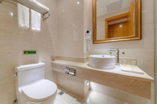 a bathroom with a white toilet and a sink at Vienna International Shenzhen Tianan Digital City in Shenzhen