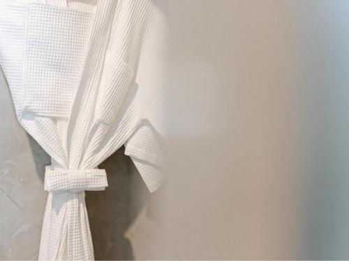 a piece of white curtain hanging on a wall at B2 Krabi Premier Hotel in Ao Nang Beach
