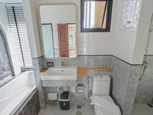 a bathroom with a sink and a toilet and a mirror at B2 Krabi Premier Hotel in Ao Nang Beach