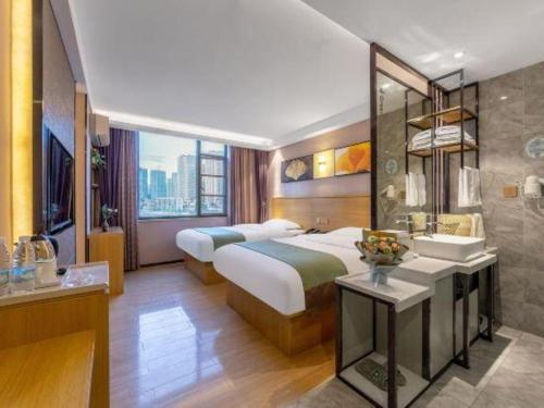 a hotel room with two beds and a bathroom at GreenTree Alliance Hotel Kunming Chuanjin Road Branch in Kunming