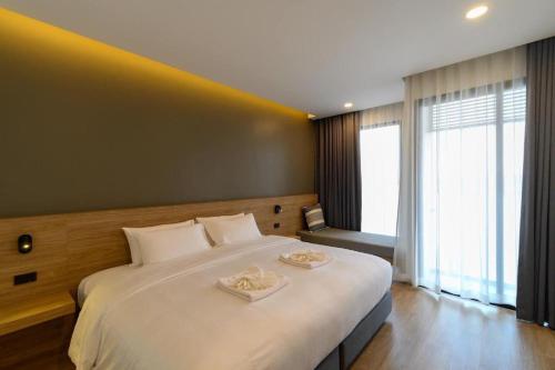 Ένα ή περισσότερα κρεβάτια σε δωμάτιο στο Chewa Khong Hotel Nakhon Phanom