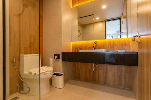 ein Badezimmer mit Toilette, Waschbecken und Spiegel in der Unterkunft Chewa Khong Hotel Nakhon Phanom in Ban Tha Khwai