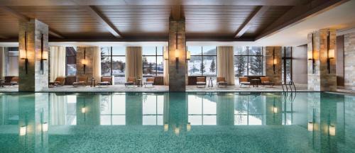 a pool in a hotel with chairs and tables at Hyatt Regency Changbaishan in Fusong