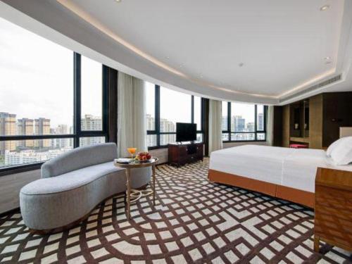 Postel nebo postele na pokoji v ubytování Hainan Junhua Haiyi Hotel