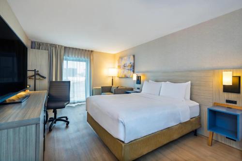 a hotel room with a large bed and a television at Comfort Inn Gatineau in Gatineau