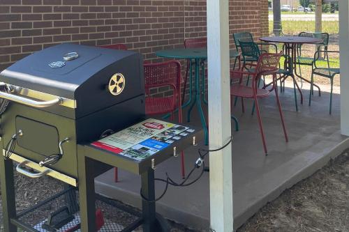 a grill on a patio with a table and chairs at Quality Inn Kenly I-95 in Kenly
