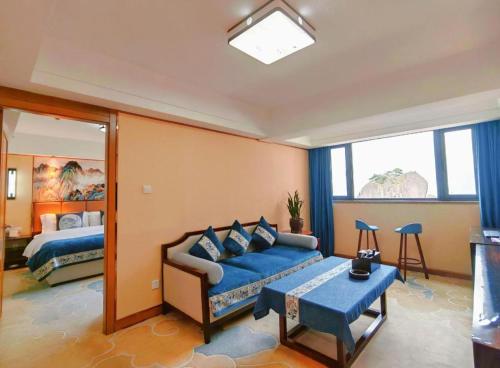 a living room with a couch and a bed at Huangshan Yupinglou Hotel in Huangshan