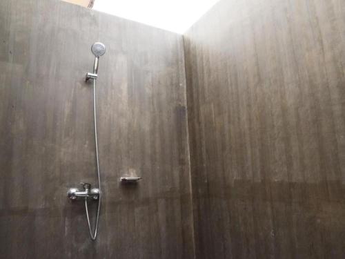 a shower with a shower head in a bathroom at Juntima Boutique Hotel in Ban Rong Rakam