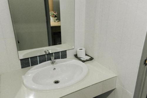 a bathroom with a white sink and a mirror at Urban House 195 in Chiang Mai