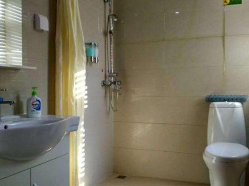 a bathroom with a sink and a toilet at The Century Seaview Hotel in Shenzhen