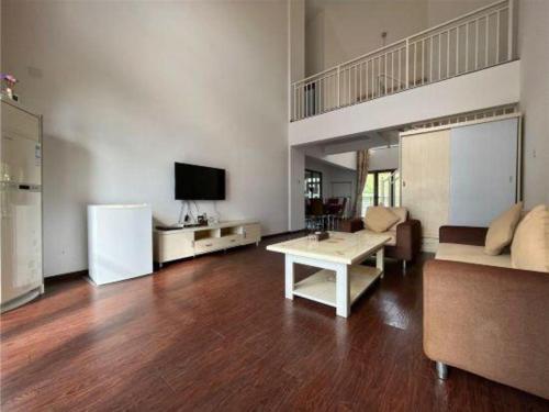 a living room with a couch and a table at The Century Seaview Hotel in Shenzhen