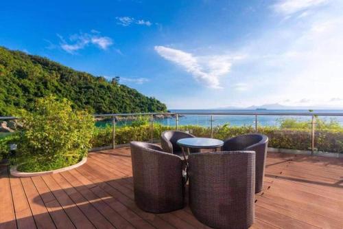 a balcony with a table and chairs and the ocean at The Century Seaview Hotel in Shenzhen