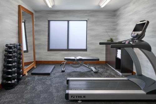 a room with a gym with a treadmill and a mirror at Fairfield Inn by Marriott Rochester East in Webster