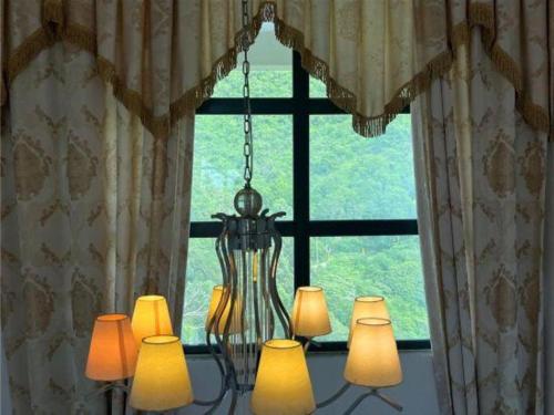 a group of lights in front of a window at The Century Seaview Hotel in Shenzhen
