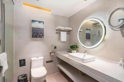 a bathroom with a sink and a mirror at Lavande Hotel Guangzhou Financial City Tianhe Park Metro Station in Guangzhou